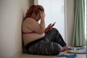 plus size asian sport woman havinge some cyberbullying for her obesity